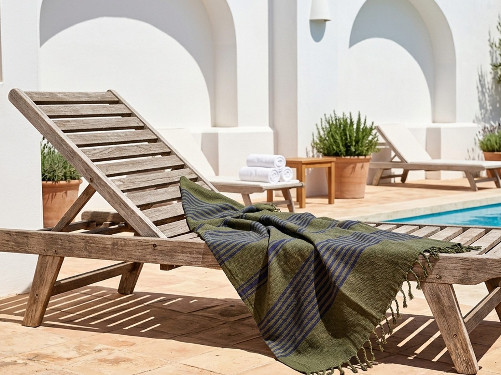 Striped peshtemal draped over a poolside lounger