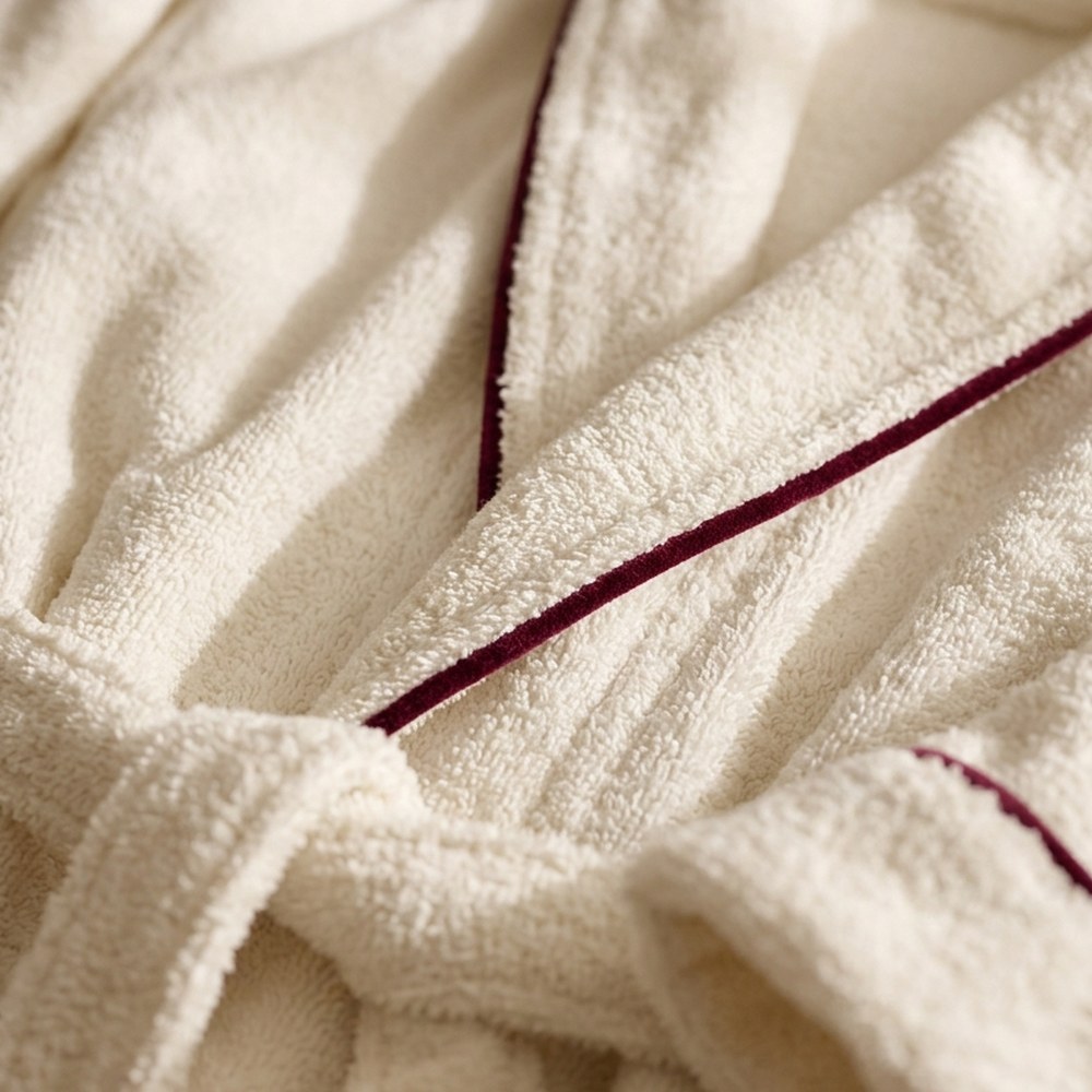 Detail of bathrobe shawl collar and belt with burgundy piping